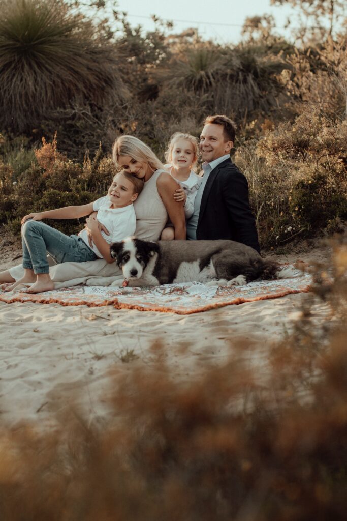 An image from a legacy session with The Lifestyle Phodographer, of Alex the dog and his loving family together in a Perth park. 